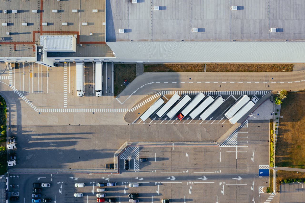 Drone shot of a logistics center with trucks and parking lot in Poznań, Poland.