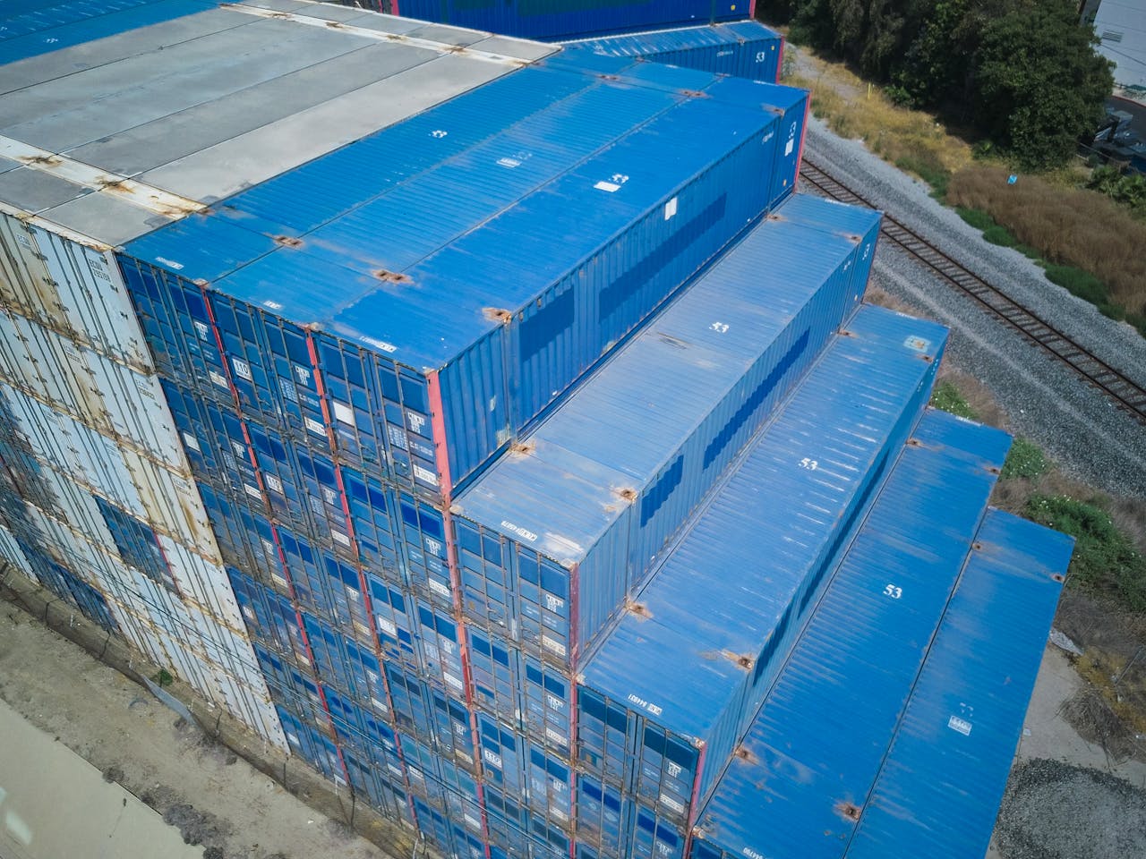 Overhead shot of blue cargo containers stacked for logistics and storage.